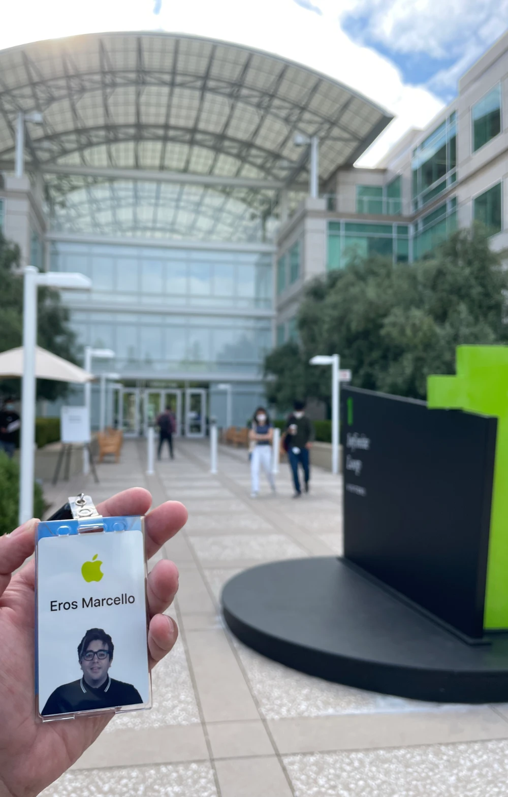Eros Marcello holding his Apple badge outside Apple's Infinite Loop campus